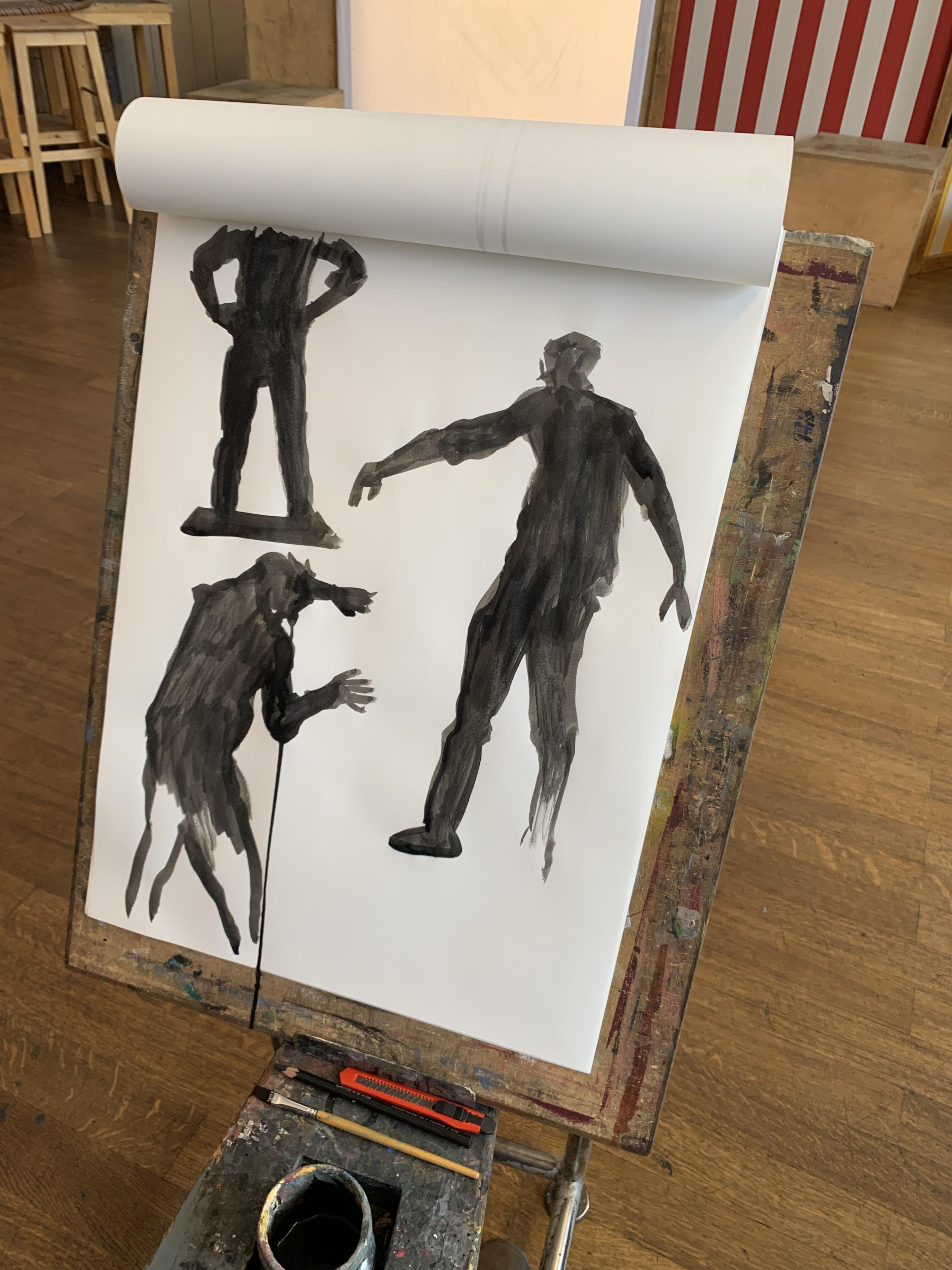 Artist's sketch pad showing black figure drawings of silhouettes in dynamic poses on white paper