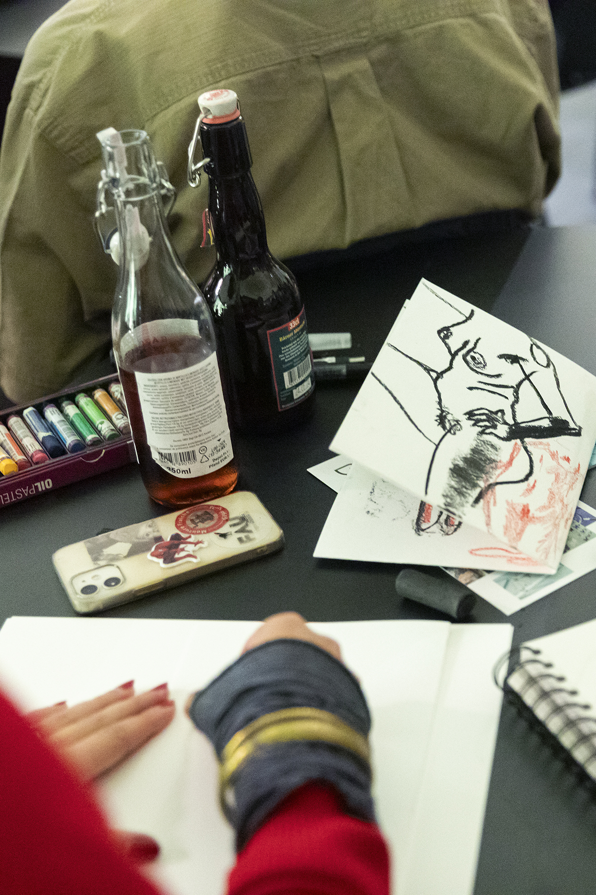 Overhead view of a workspace with Japanese calligraphy materials, ink bottle, and paper scrolls