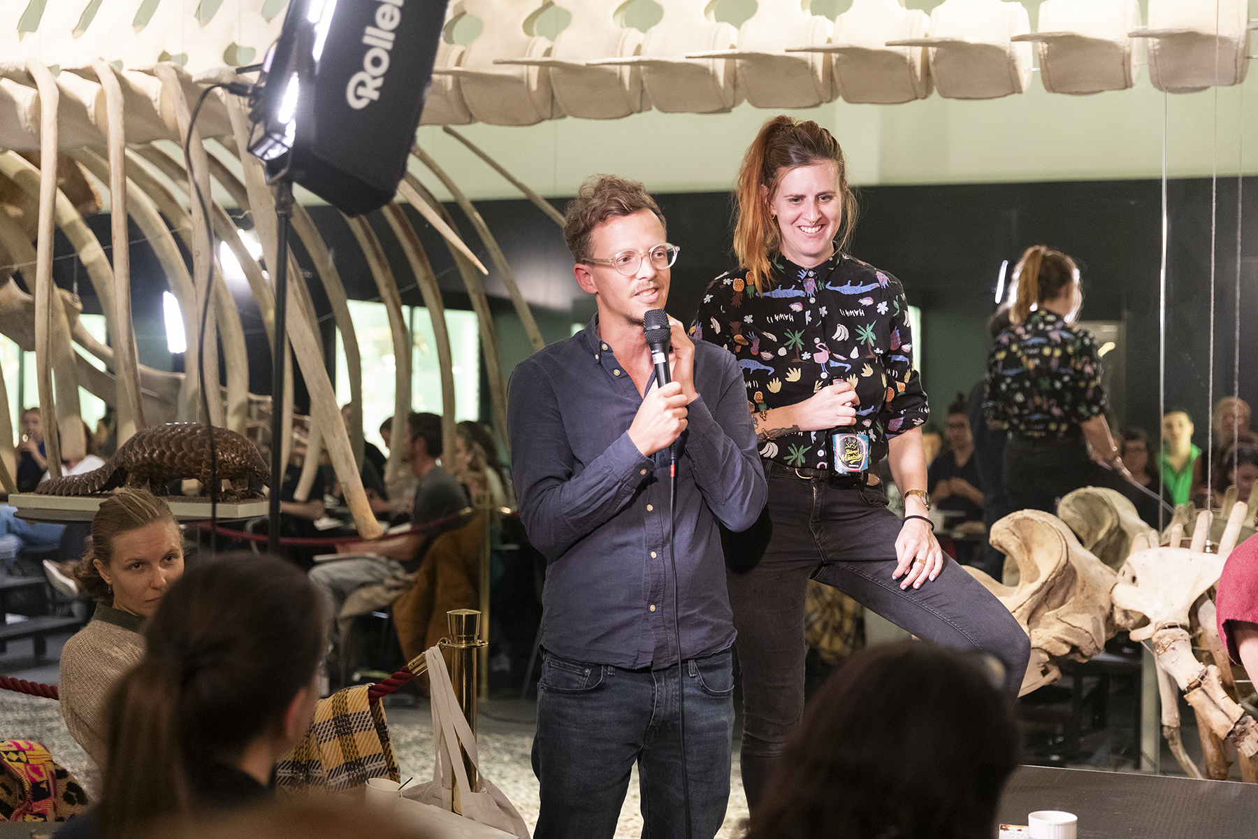People celebrating and toasting with drinks in a rustic venue with exposed wooden beams